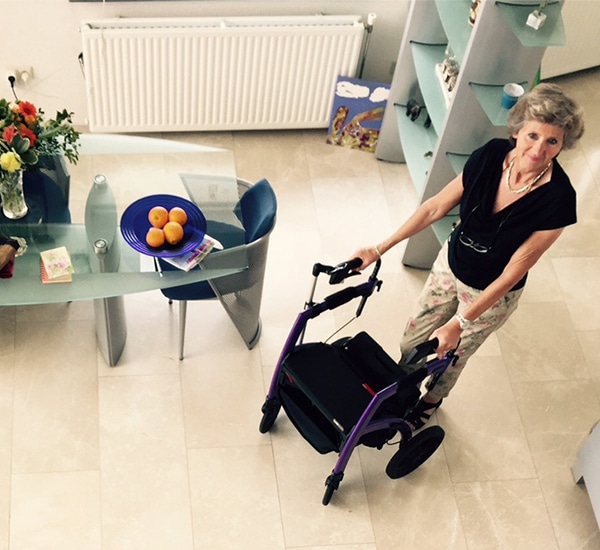 Woman using a Rollz Motion stable rollator inside her house